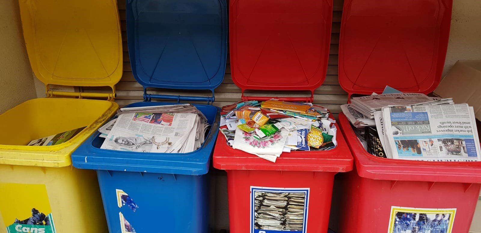 Colour-Coded Recyclables and Wastes Recycling bins with sorted paper and materials in Singapore