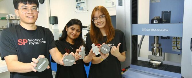 Singapore Polytechnic students showcasing biochar cement samples used in sustainable construction research.