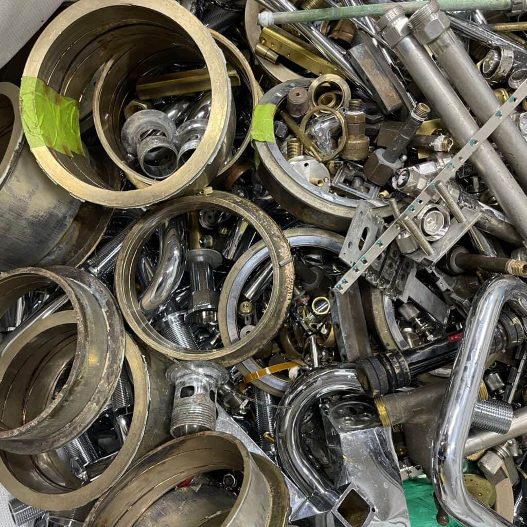 Mixed brass fittings and metal parts collected for recycling and recovery in Singapore.