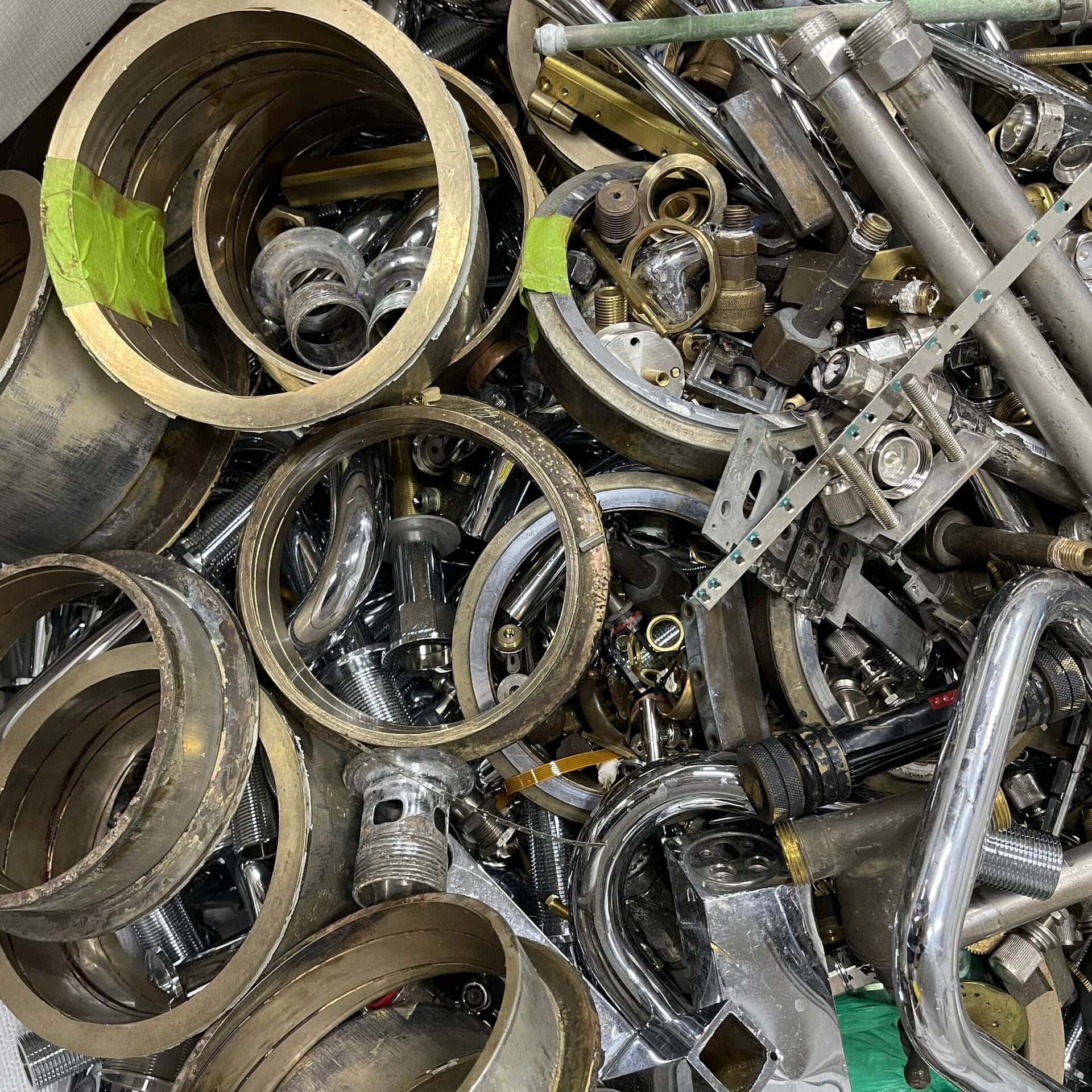 Mixed brass fittings and metal parts collected for recycling and recovery in Singapore.