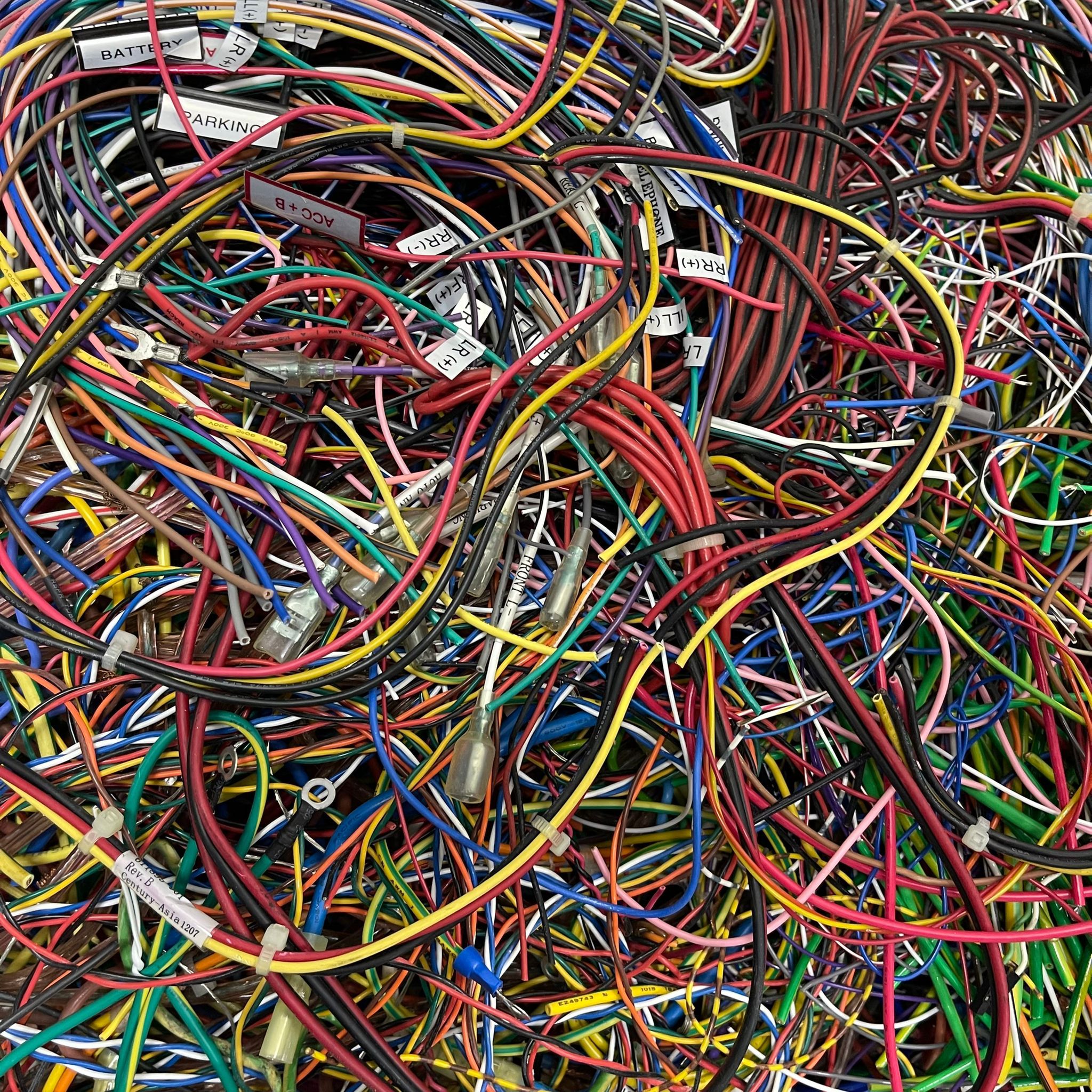 Assorted coiled and insulated wires collected for recycling and copper recovery in Singapore.