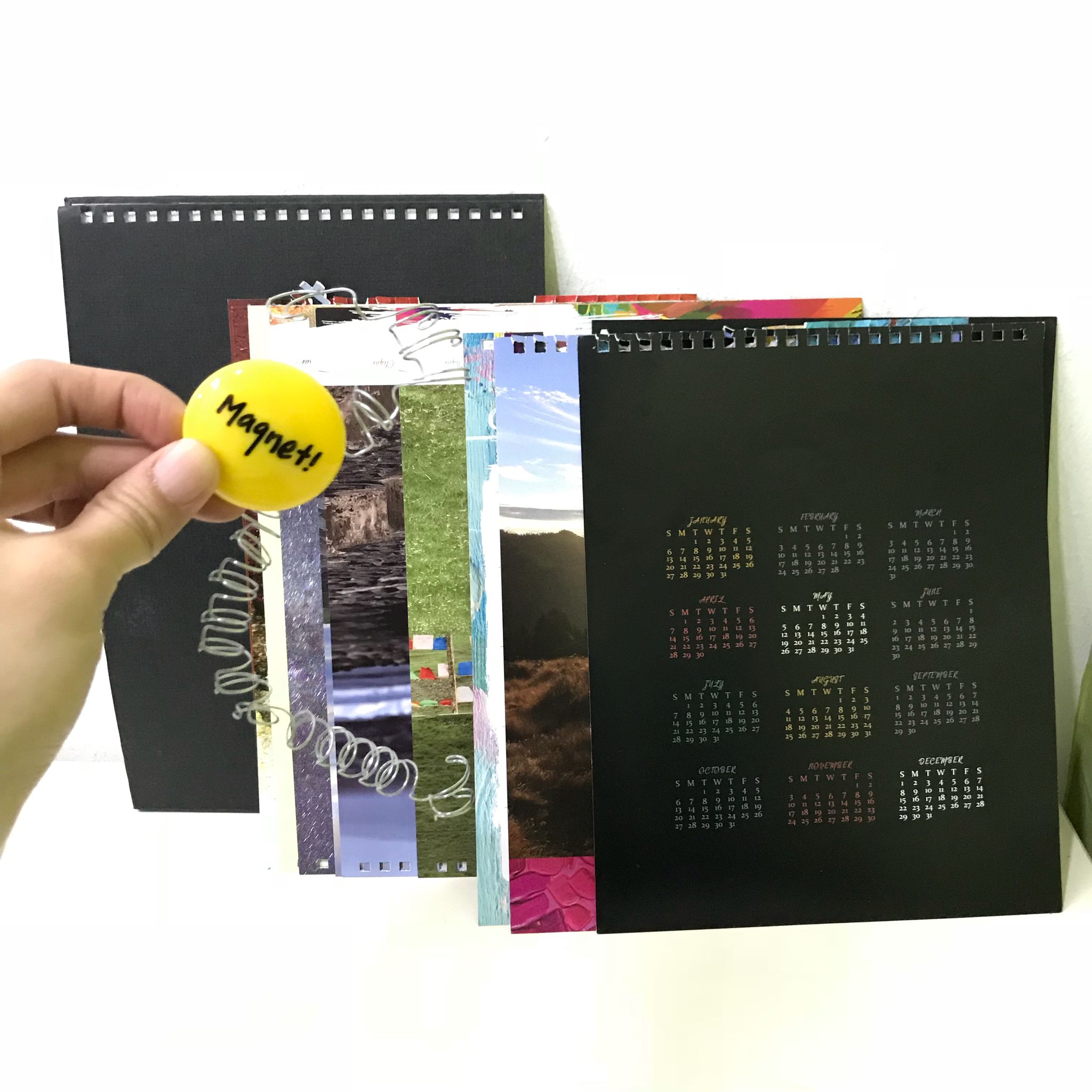 Scrap table calendar metal binders recycling wire binder need to be removed Used table calendars with metal wire binders showing proper separation for recycling in Singapore.