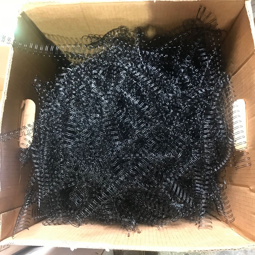 Scrap table calendar metal binders recycling Used table calendars with metal wire binders showing proper separation for recycling in Singapore.