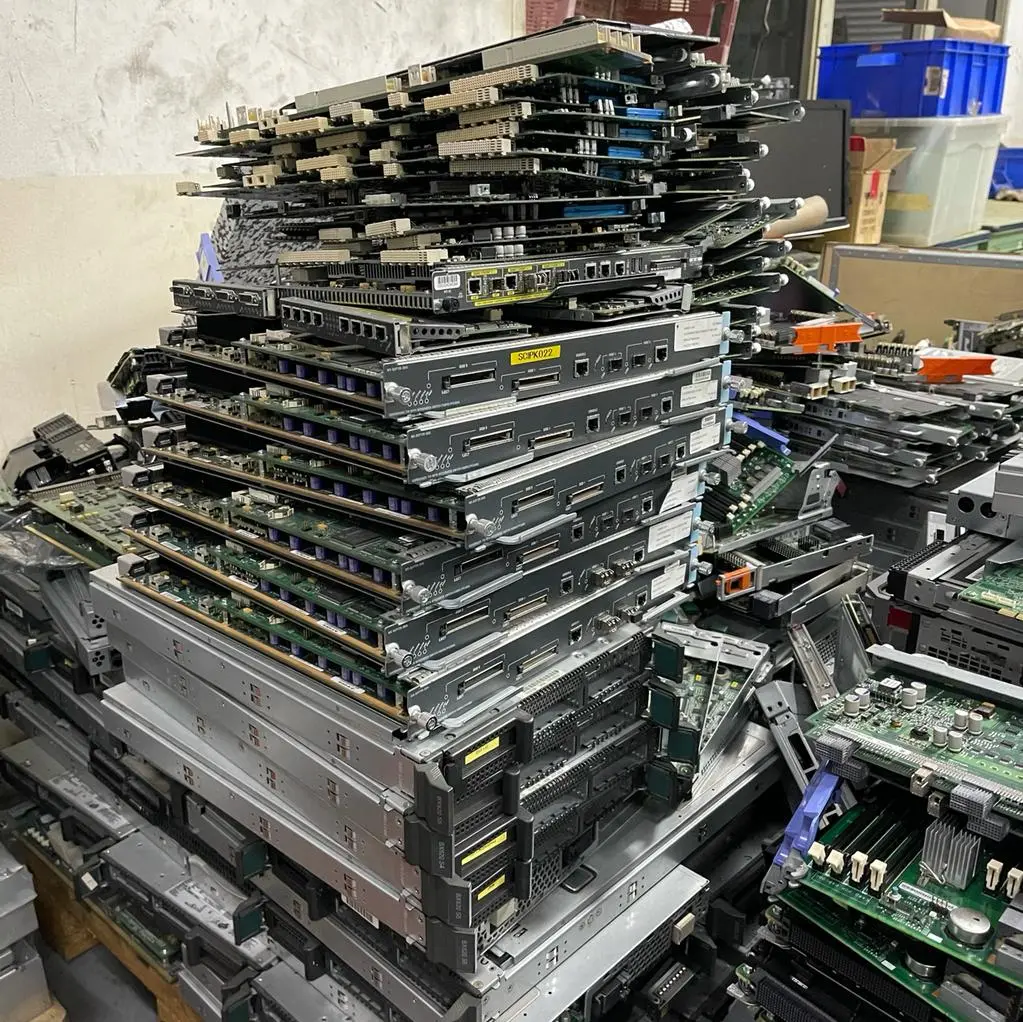 Stack of dismantled servers and network equipment prepared for e-waste recycling at Gee Hoe Seng Pte Ltd facility in Singapore.