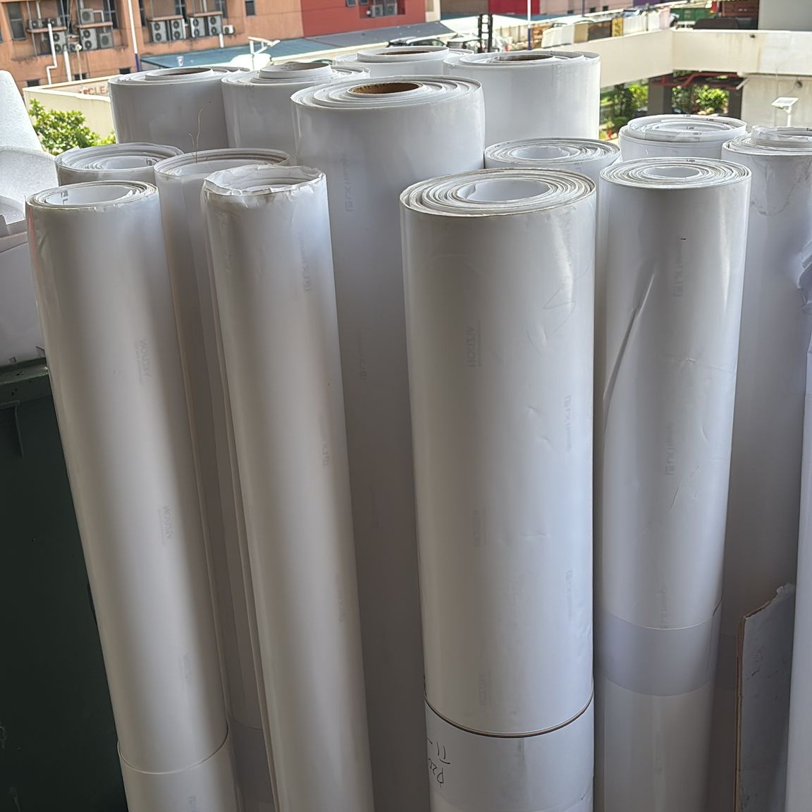 Rolls of wax paper with glossy coating prepared for proper disposal in Singapore.